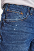 Jean skinny azul oscuro con rotos, parches y detalles en láser