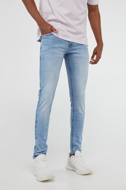 Jean skinny azul medio con costuras en contraste y desgastes