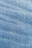 Jean tiro bajo slim azul medio con desgastes de color y 5 bolsillos