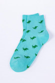 Medias largas azules claras con diseños de dinosaurios verdes
