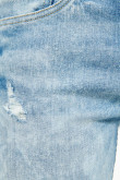 Jean slim azul claro tiro bajo con rotos y detalles desteñidos