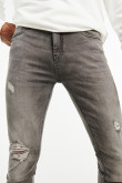 Jean gris oscuro súper skinny con desgastes de color y rotos