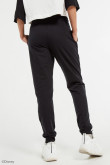 Pantalón negro jogger con estampado lateral de Disney 100