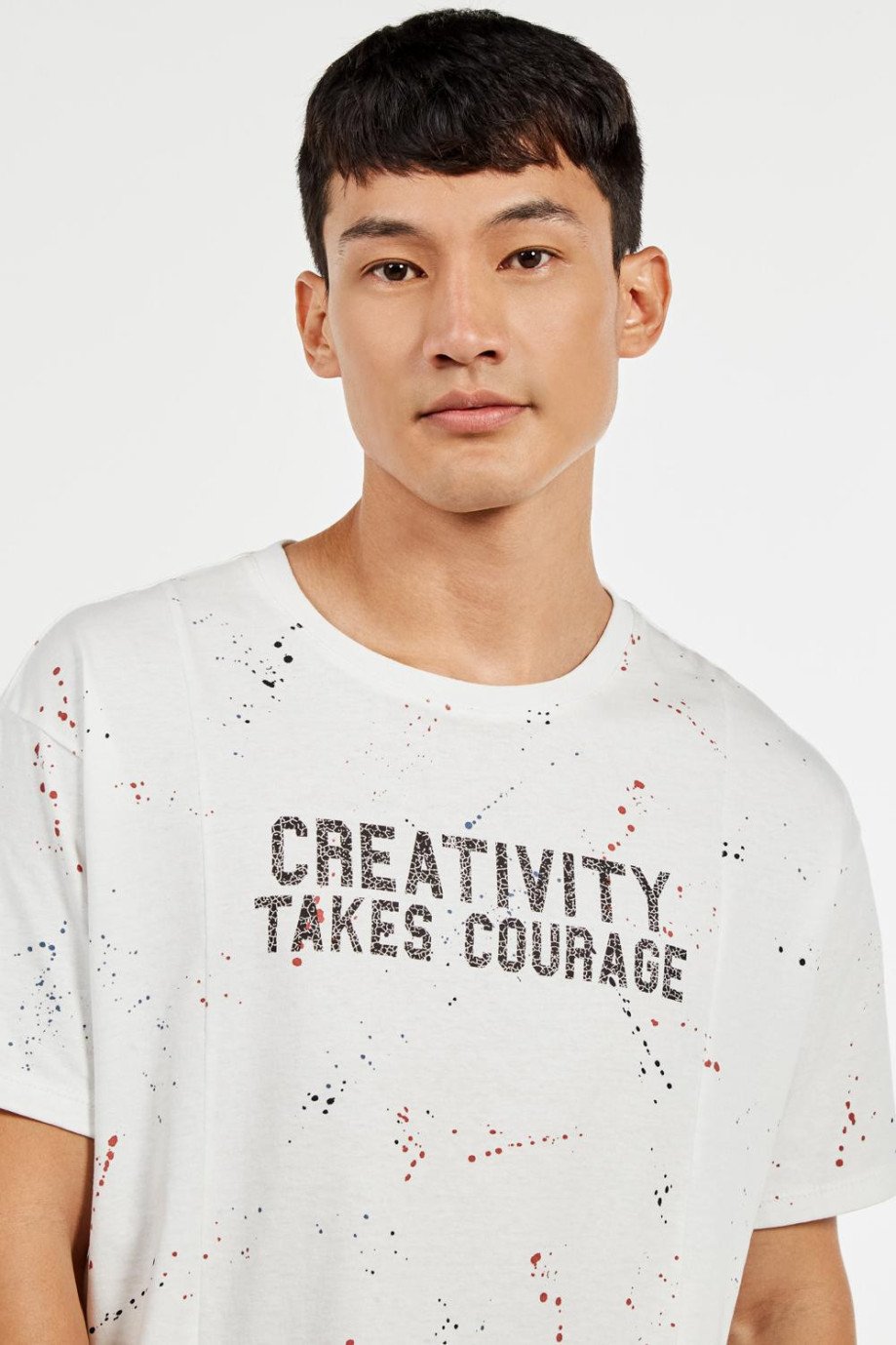 Camiseta manga corta crema clara oversize con estampados de manchas y texto