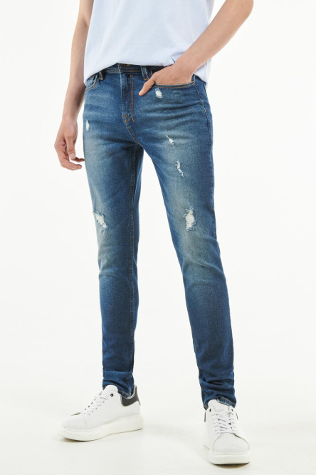 Jean skinny azul intenso con rotos y costuras amarillas