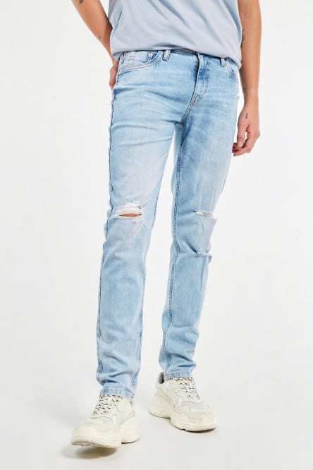 Jean skinny tiro bajo azul con bolsillos y rotos en frente