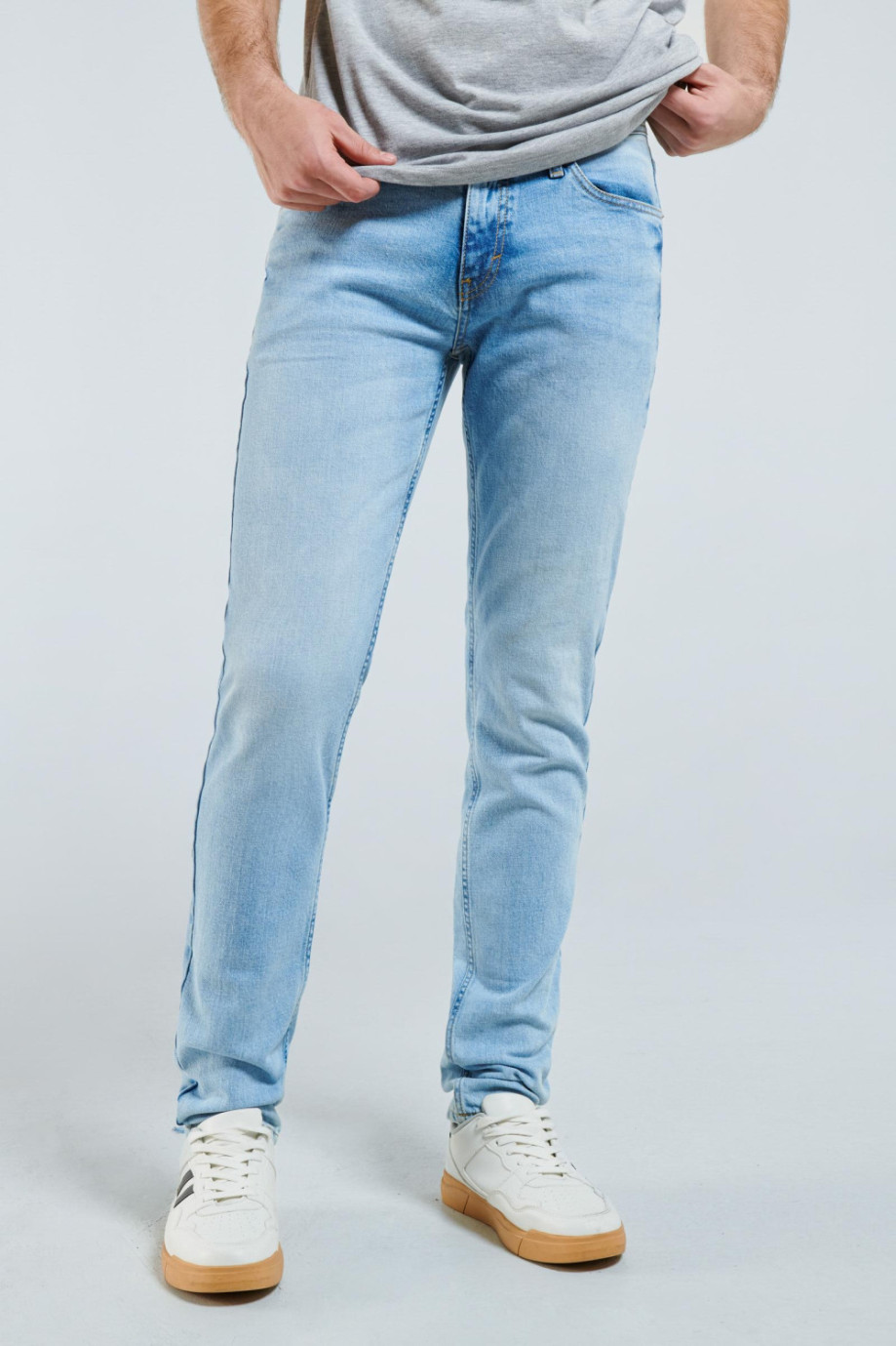 Jean azul claro tipo slim con ajuste ceñido, tiro bajo y 5 bolsillos