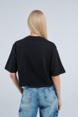 Camiseta oversize crop top negra con diseño blanco de Coca-Cola