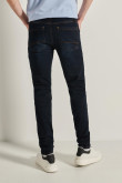 Jean skinny ajustado azul con costuras cafés y tiro bajo