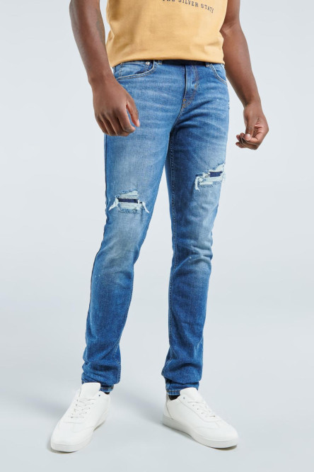 Jean azul oscuro skinny con rotos y diseños de salpicaduras