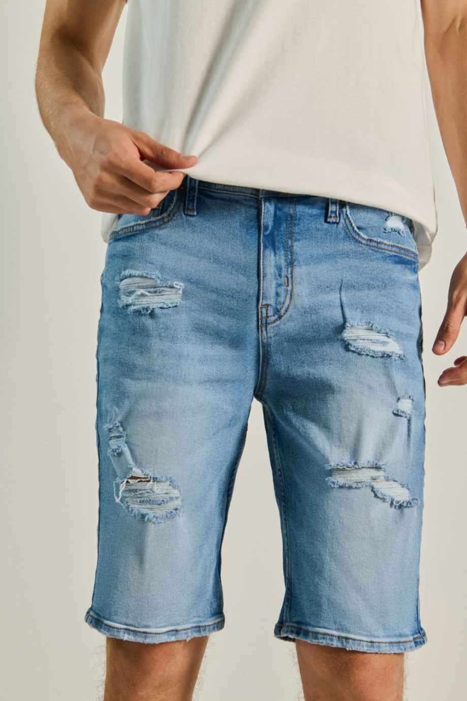 Bermuda slim azul en jean con rotos en frente y tiro bajo