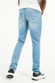 Jean skinny tiro bajo azul claro con rotos y estampados