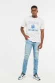 Jean skinny tiro bajo azul claro con rotos y estampados