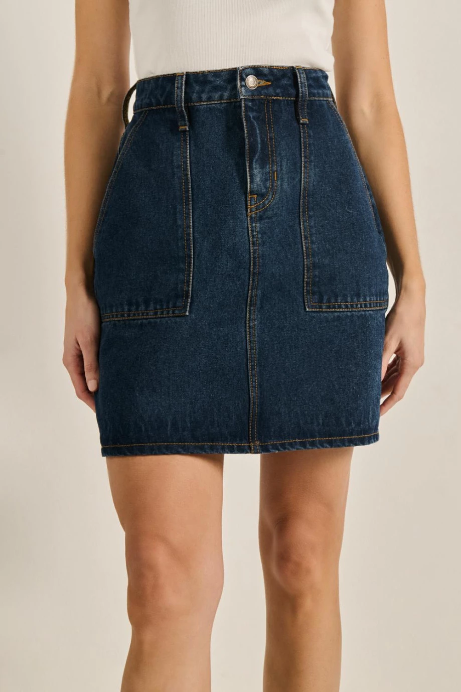 Falda azul corta en jean carpintero con bolsillos de parche