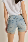 Short tiro medio en jean azul con desgastes y bolsillos