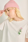 Camiseta crop top unicolor con diseño de flor en frente