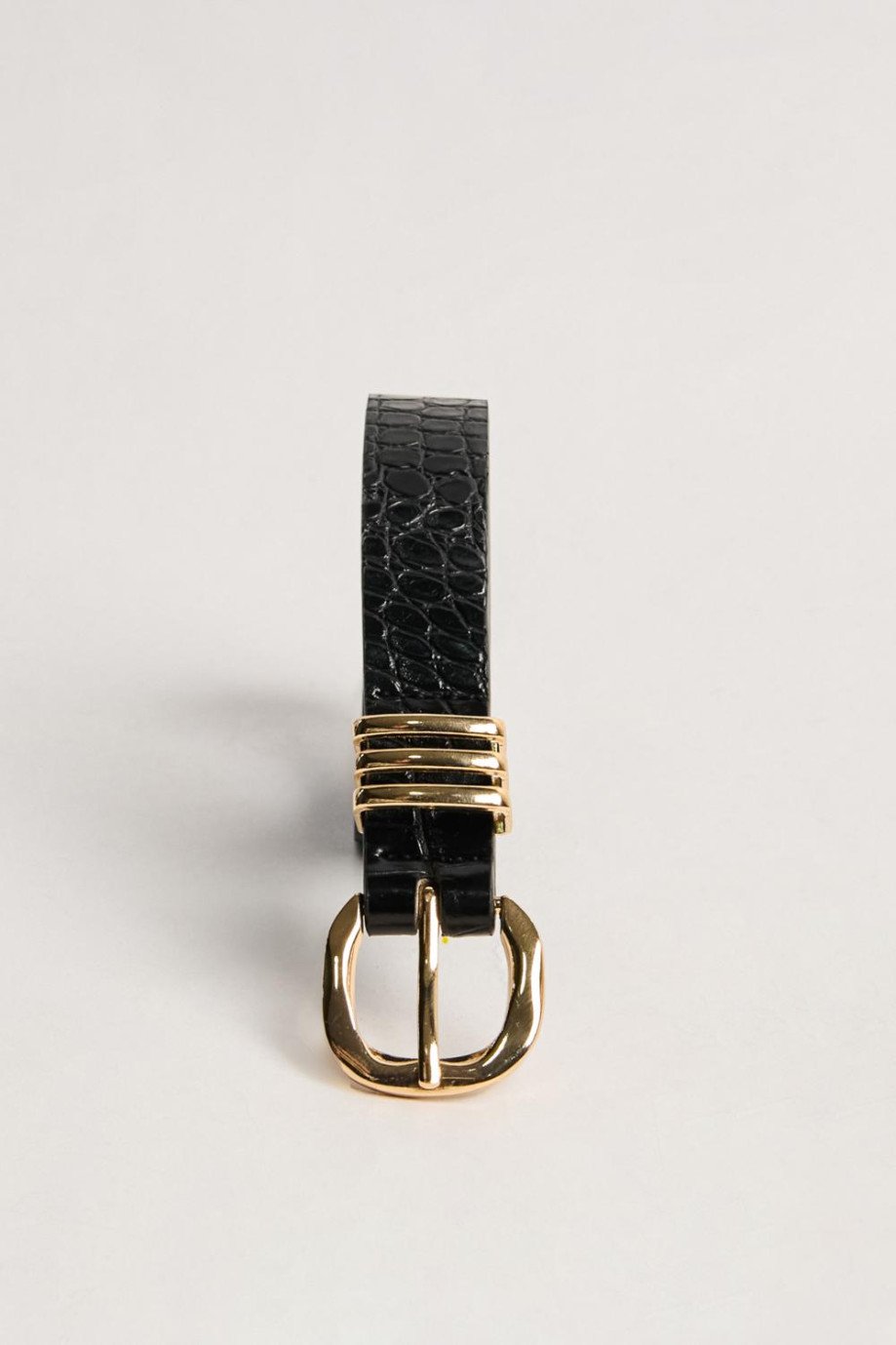 Cinturón negro con texturas, hebilla y triple trabilla