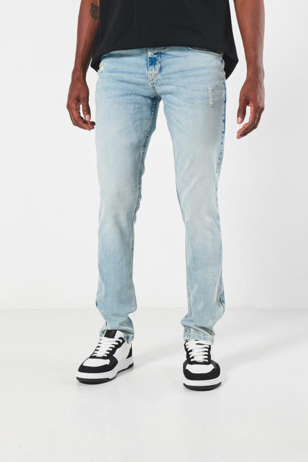 Jean skinny azul claro con rotos sutiles y tiro bajo