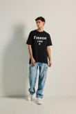 Camiseta oversize unicolor manga corta con texto college