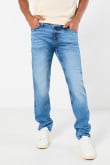 Jean azul claro slim con desgastes, cremallera y tiro bajo